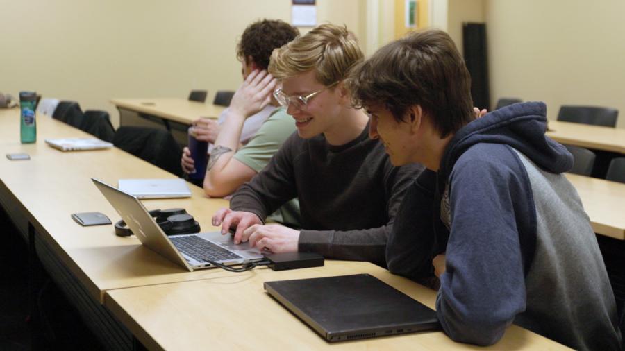 Students looking at laptop
