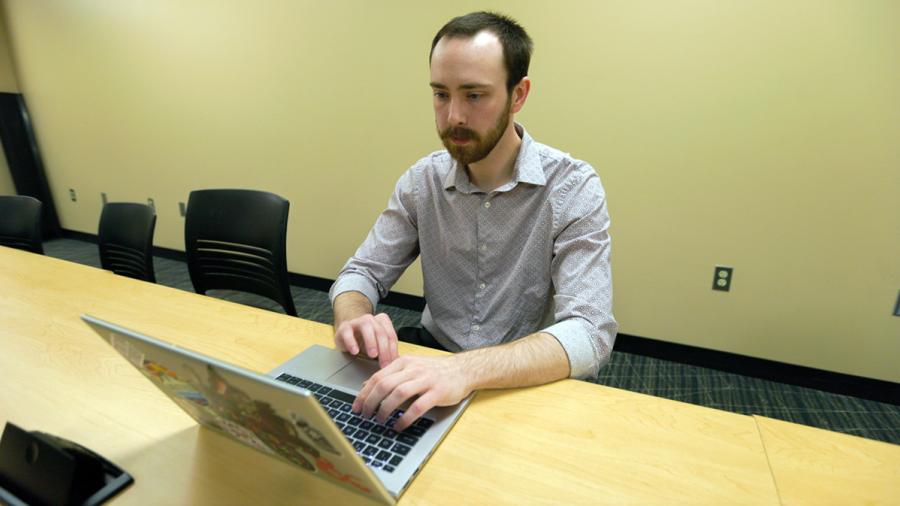 Student types on laptop