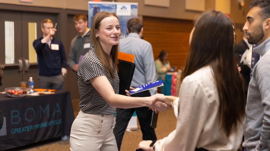 Students talk with employer recruiters at a career conference