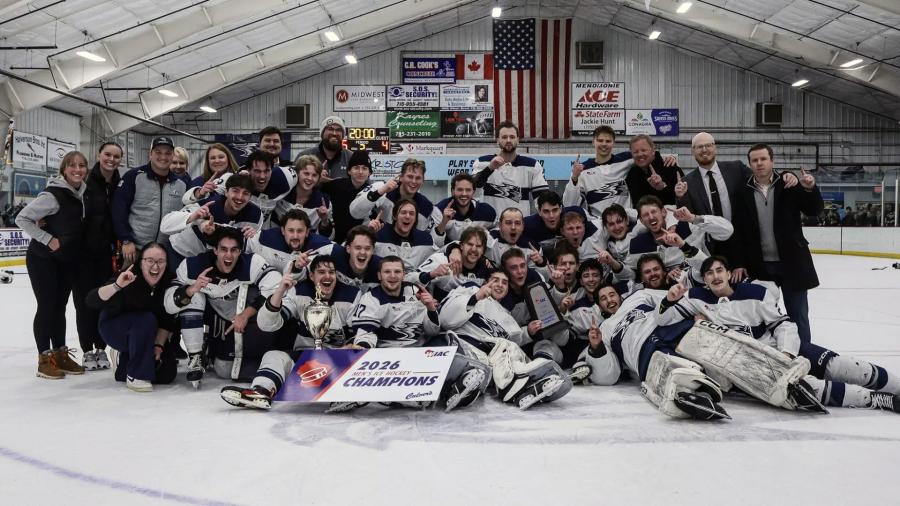 Hockey team poses with trophy