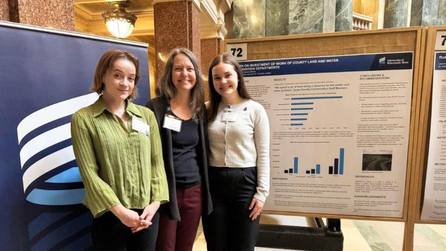 Three women in research poster