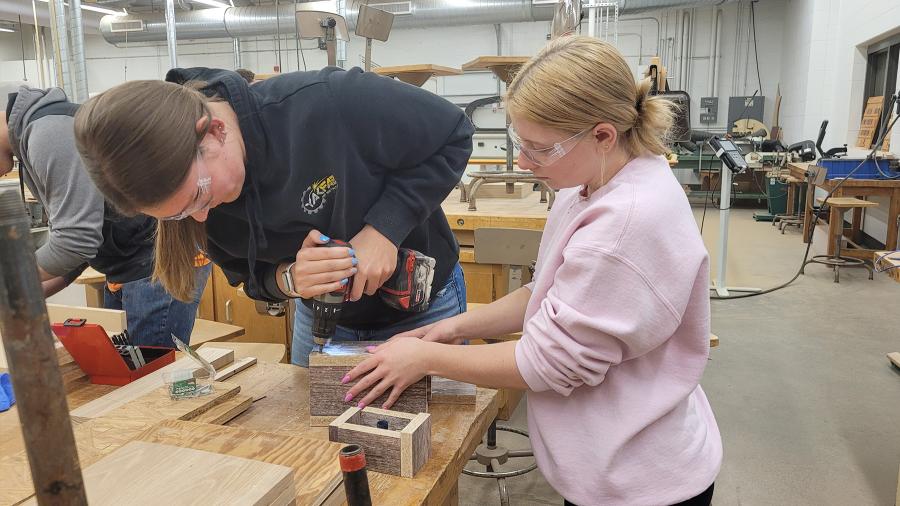 TA Annika Scheuter and Bethany Winge construct a frame for an epoxy mold pour.