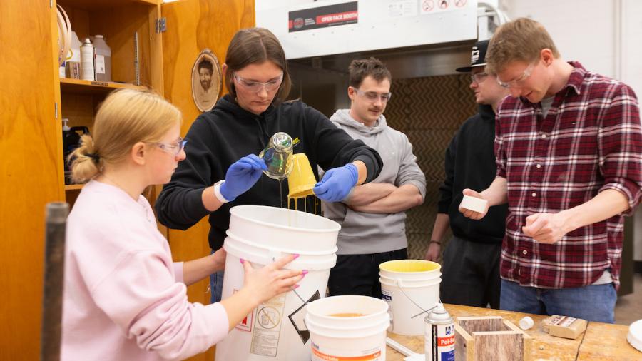 TA Annika Schleuter and Bethany Winge mix the two-part casting rubber for an epoxy mold pour.