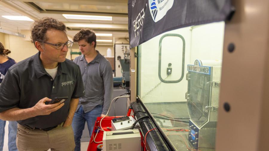 Man looking at testing chamber