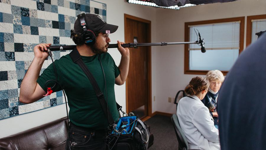 Doran Acero assists with sound on the set of Winter Hymns. Photo by Ericka Kreutz.