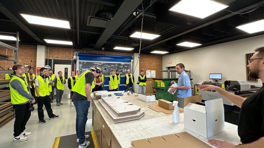 Green Bay Packaging senior designers Robert Herdina and Steve VandenAvond lead a student tour
