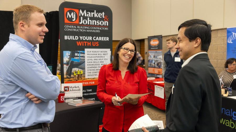 People talk at a corporate booth