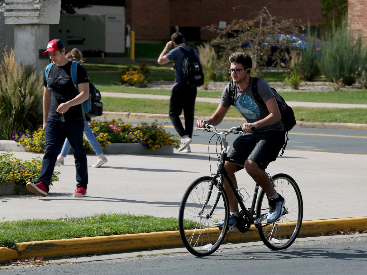 A student bikes through campus recently. 
