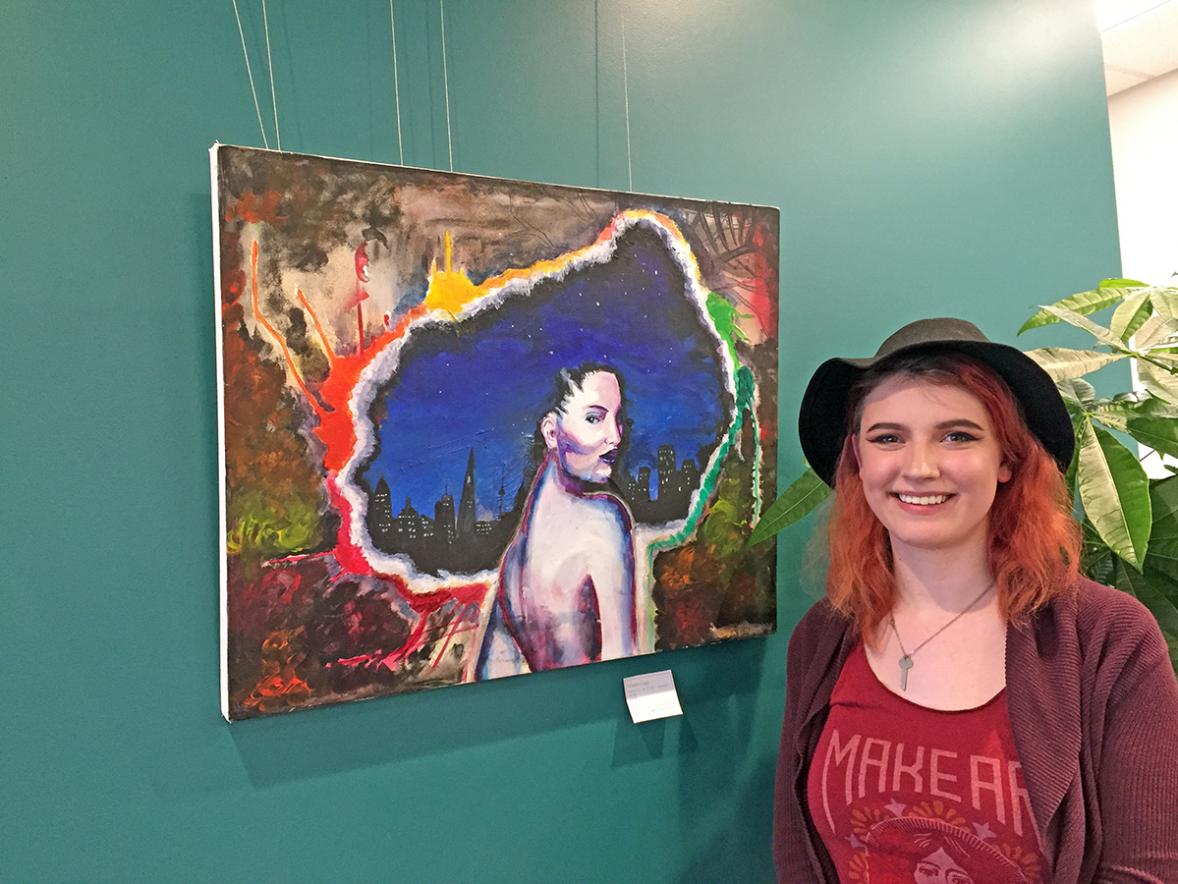 UW-Stout student Stephanie Howell with her artwork “Urbanology.” Howell’s illustrations are on display at the Menomonie Market Food Co-op gallery through April. /UW-Stout photos by Pam Powers