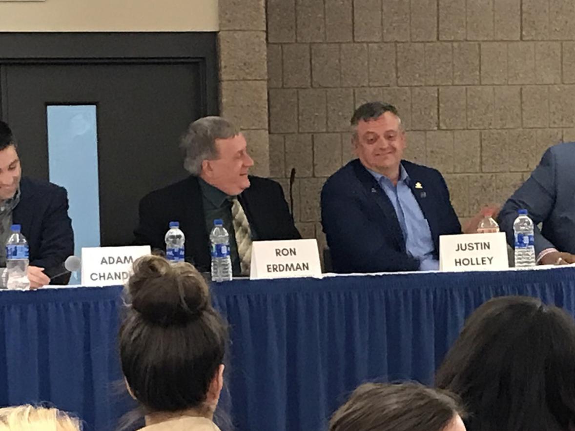 UW-Stout alumnus Michael Wilson, right, laughs during a panel discussion at the School of Hospitality Leadership 50th anniversary event. 
