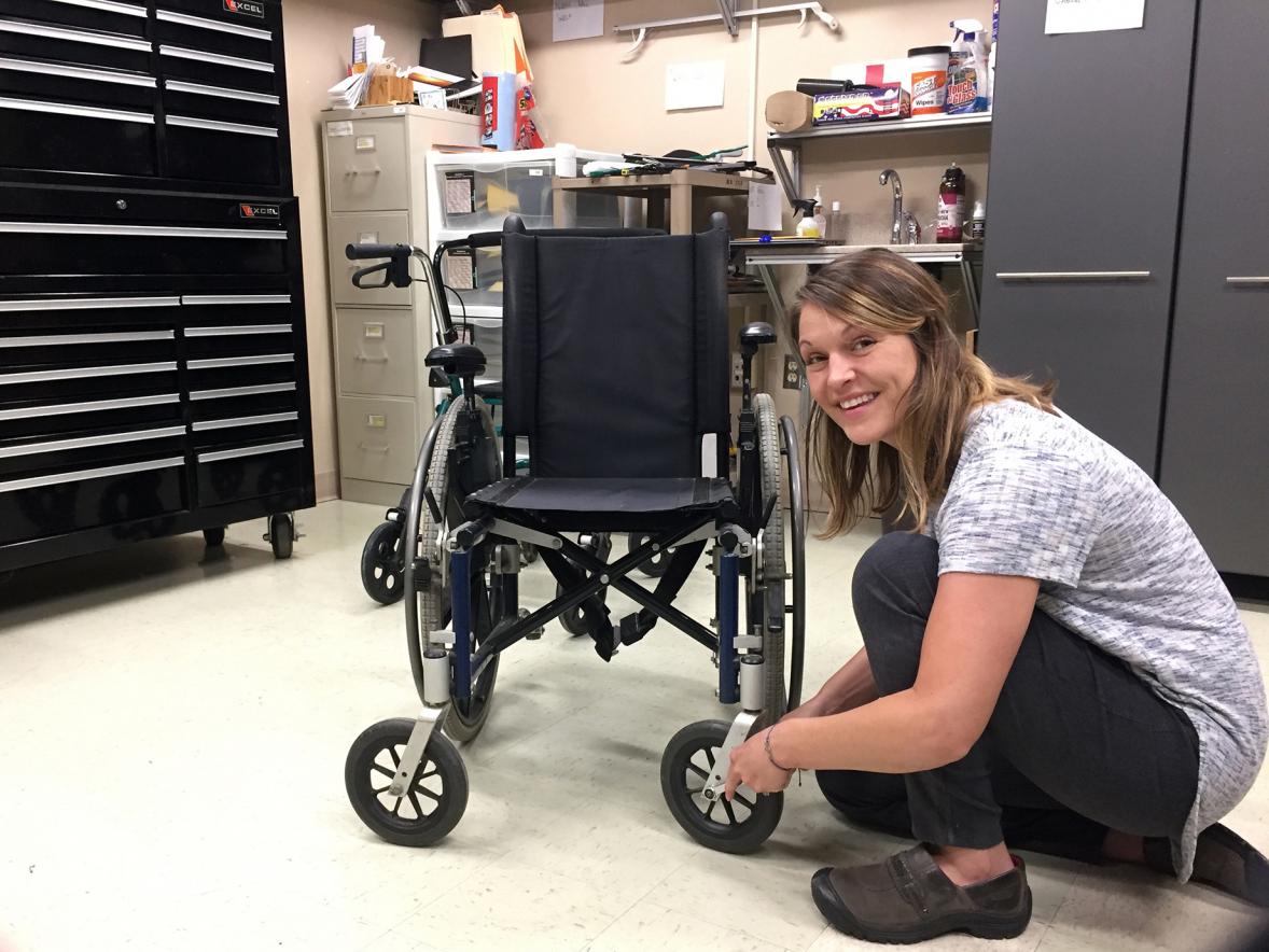 Hayley Bollinger, an assistive technologist with the Stout Vocational Rehabilitation Institute, works on maintaining a wheelchair at the UW-Stout Vocational Rehabilitation Building.
