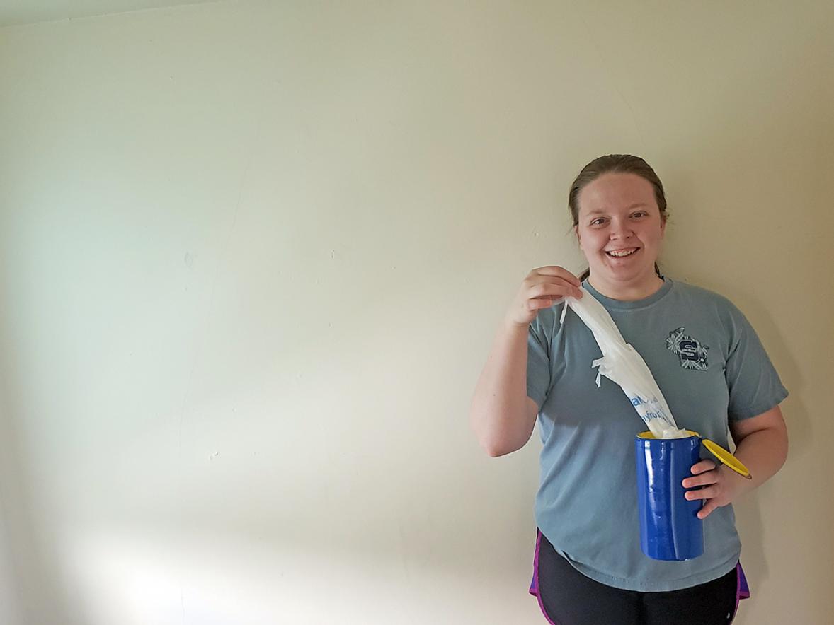 UW-Stout student Kadi Wright with her canister to store and reuse plastic bags. Wright made a how-to video on how to make the canister to help celebrate Earth Week.
