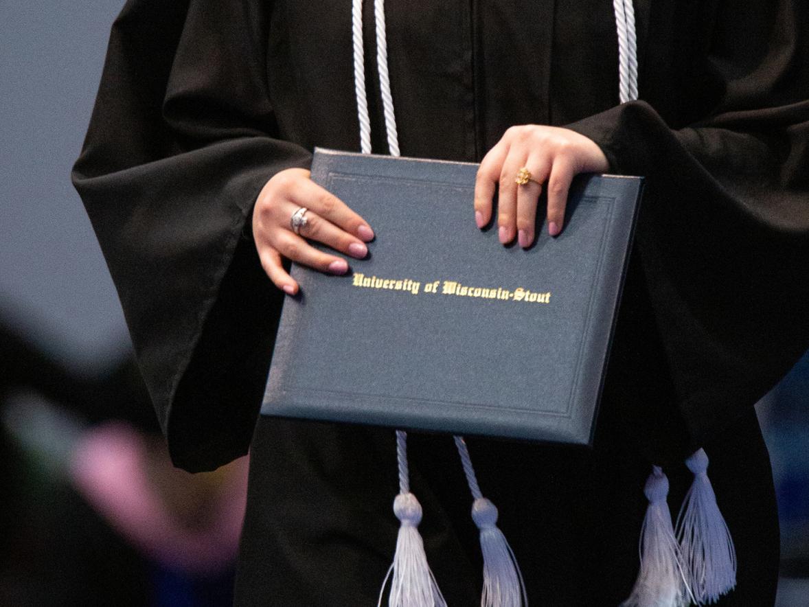 A graduate clutches her diploma at a recent commencement.