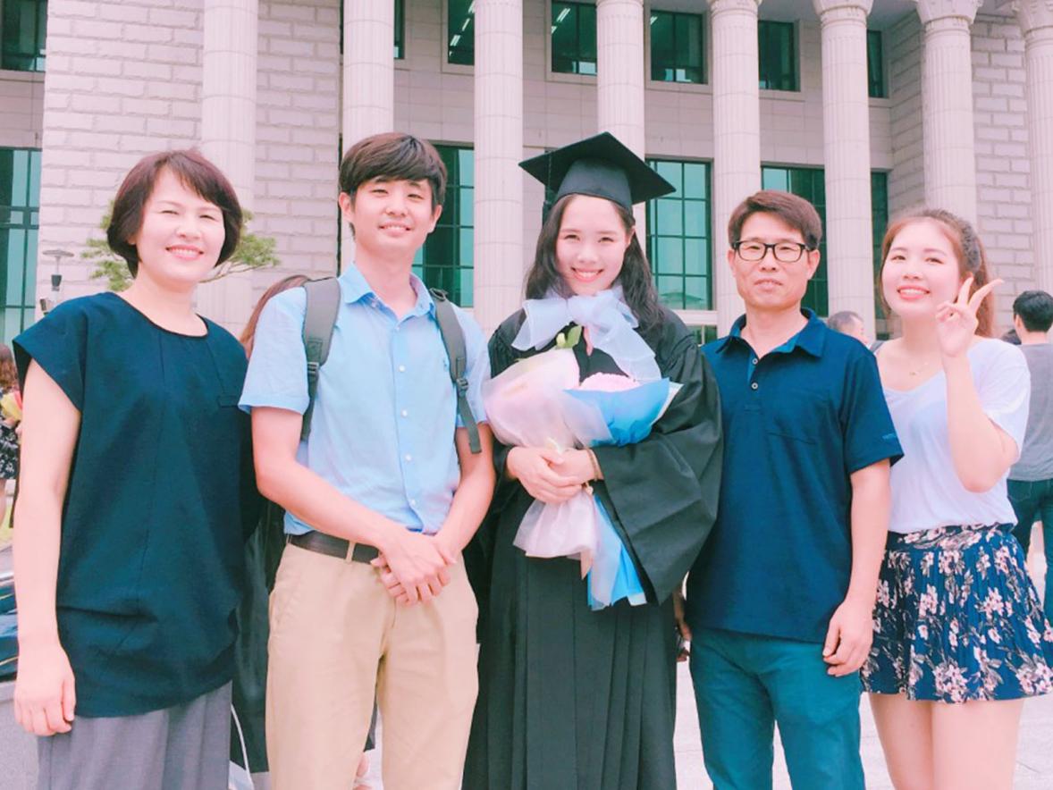 Jeongwon Kim, center, with her family at her graduation from Hankuk University of Foreign Studies.