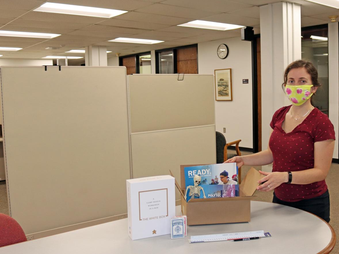 Rebecca Thacker, program manager for Professional Education Programs and Services, at UW-Stout packs one of the boxes for the Summer STEAM Experience.