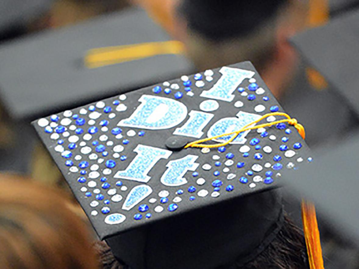 A student from a commencement ceremony prior to the pandemic celebrated with a special mortarboard.