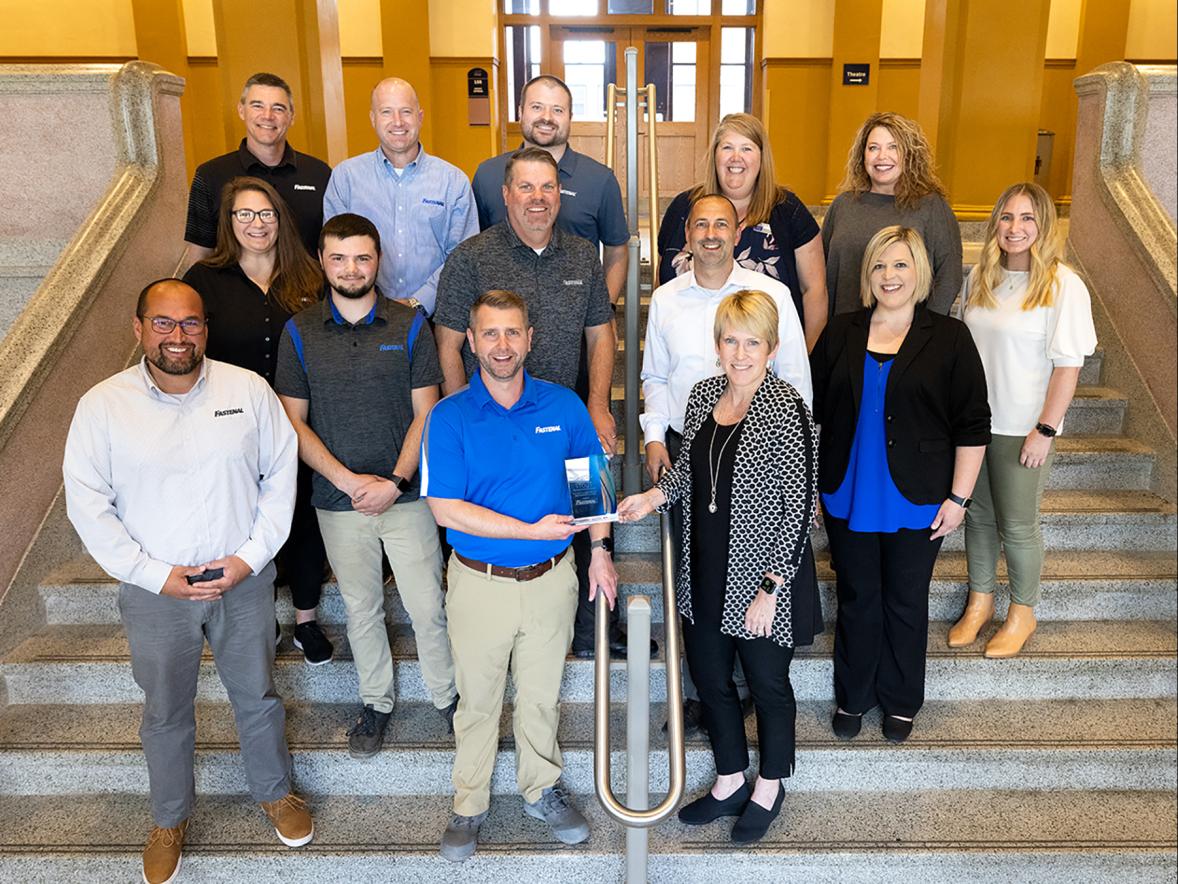 Chancellor Katherine Frank presents the UW-Stout Career Services 2022 Employer of the Year award to Justin Oleson, general manager of the Fastenal in Menomonie. Seven Fastenal representatives toured campus and met with UW-Stout officials and professors as part of the award event.