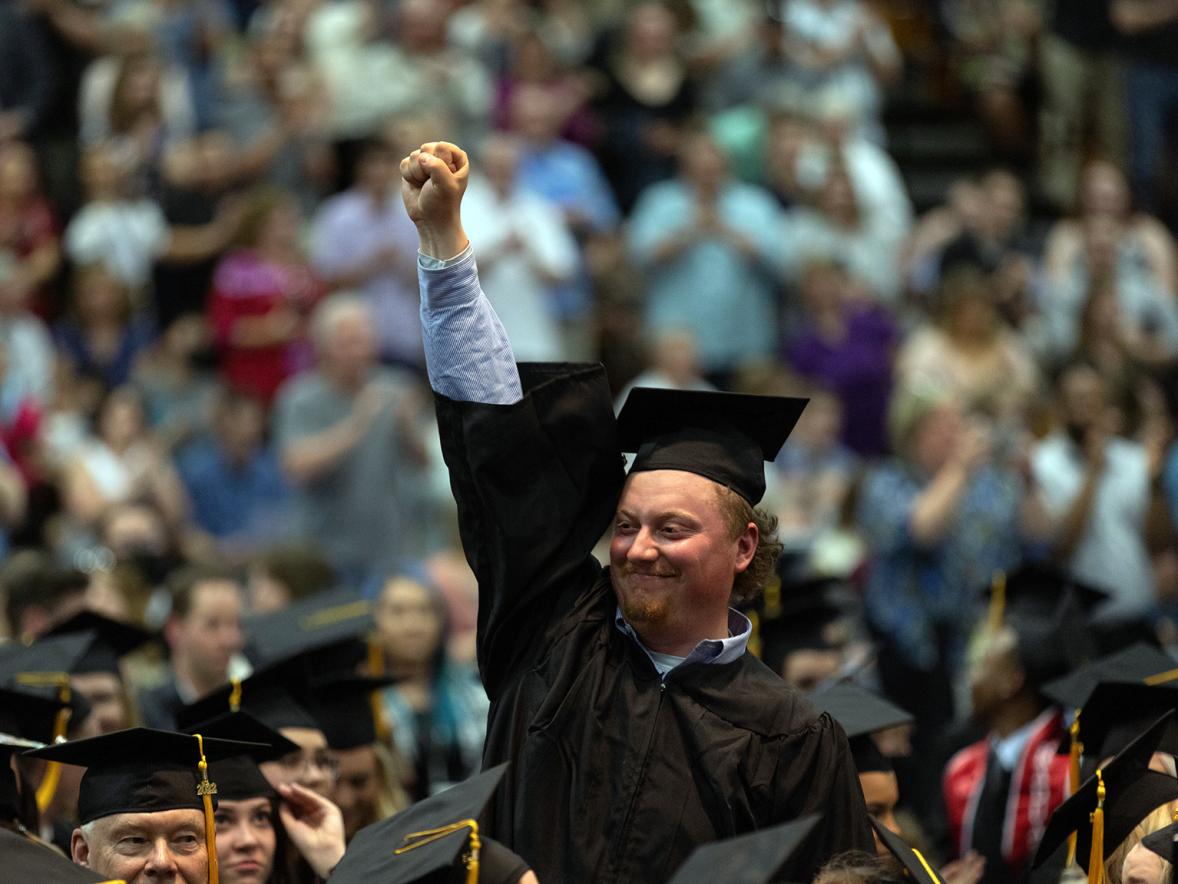 A student celebrates after graduating in spring 2022.