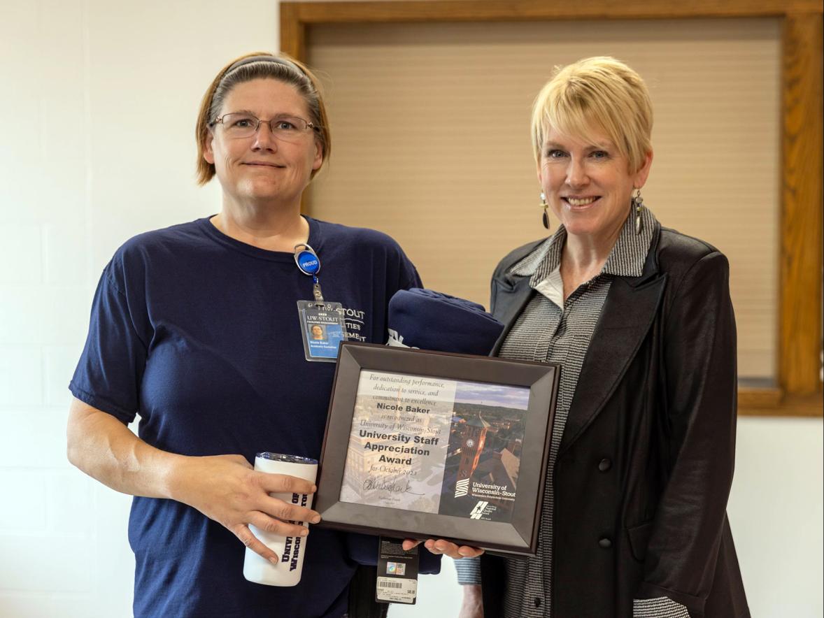 Nicole Baker, left, receives the October University Staff Employee Appreciation award from Chancellor Katherine Frank.
