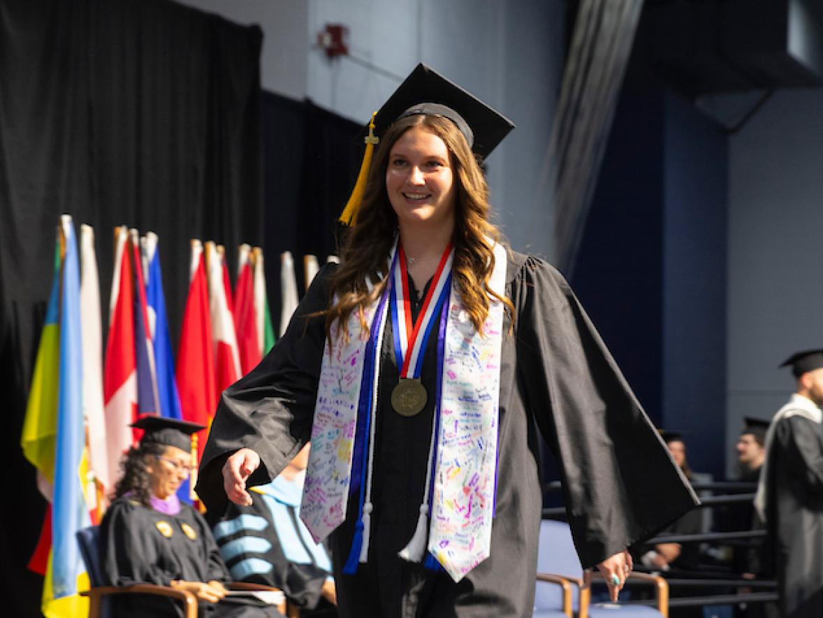 Kloie Potts crosses the commencement stage at graduation