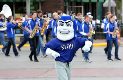 Blaze, the UW-Stout mascot, dances to Blue Devil Jazz Project band during the Homecoming Parade.