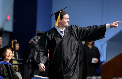 Nick Super celebrates during his walk across the Johnson Fieldhouse stage to receive his diploma.