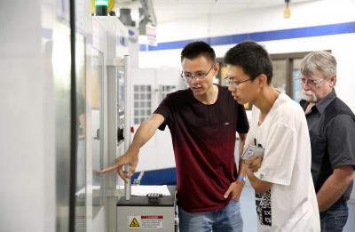 international students engaging with machinery