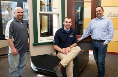 Colin Nevin, Andersen performance engineer, Brad Lorrigan, UW-Stout engineering technology student and Scott Bowe, Andersen engineering manager, pose in the window display area at the Andersen Corporation in Menomonie.