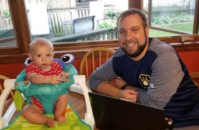 Online management student Elijah Zimmerman, at home with family.