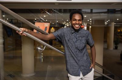 Deon Canon, double major graduate in professional communication and emerging media and applied social sciences, in the Memorial Student Center grand stairwell.