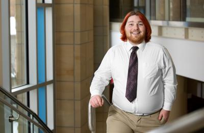 Zach Porter, entertainment design graduate, in the grand stairwell at Memorial Student Center.