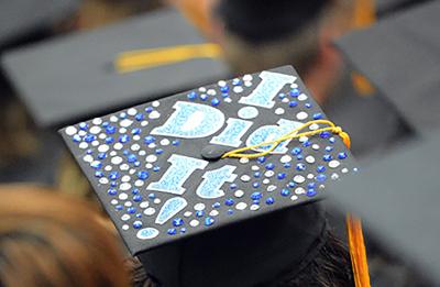 A student from a commencement ceremony prior to the pandemic celebrated with a special mortarboard.