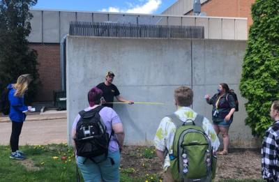 Students preparing the loading dock wall for a mural.