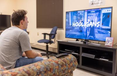 Student playing video game in library