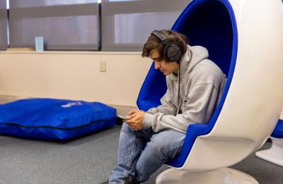 Student listening to music in the library