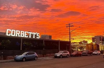 Outside of Corbett's with sunset in the background.