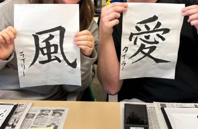 Two participants holding up their 