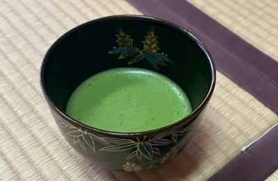Cup of Japanese tea on a bamboo mat