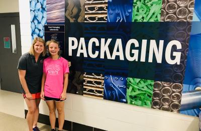 Brianne Maier and a student stand beside a packaging display in UW-Stout's Prent Packaging Laboratories.