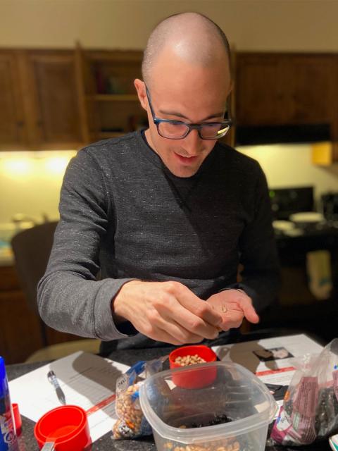 Josh Hellenbrand, management graduate, doing coursework at home.