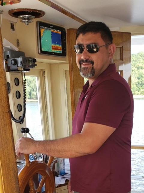 Adam Richards, supply chain management graduate, on a boat.