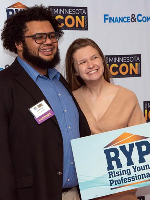 Josh Carr, of Minneapolis, a 2017 UW-Stout graduate, receives a 2021 Minnesota Finance and Commerce Rising Young Professional award recently along with another UW-Stout alum, Addie Kubitz.