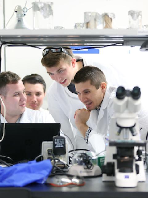 Lab Manager Josiah Ray and students in the microbiology lab