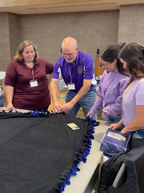 Tau members tie blankets to donate to Sleep in Heavenly Peace