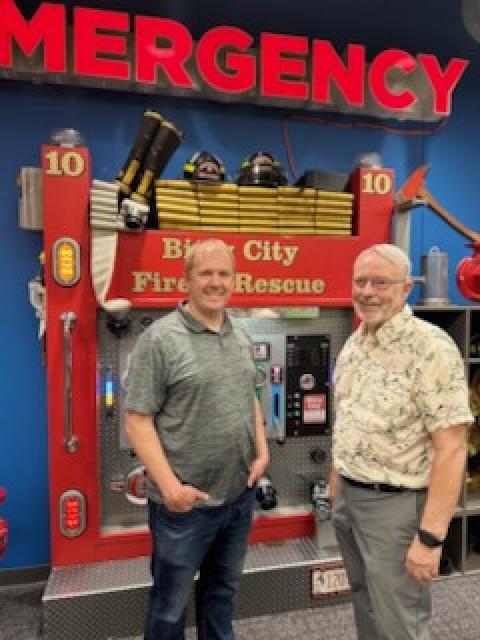 Two people stand in front of the "Bitty City Fire & Rescue" interactive exhibit at the Children’s Museum of Eau Claire.
