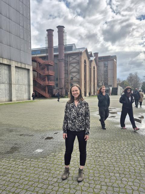 Woman stands on campus
